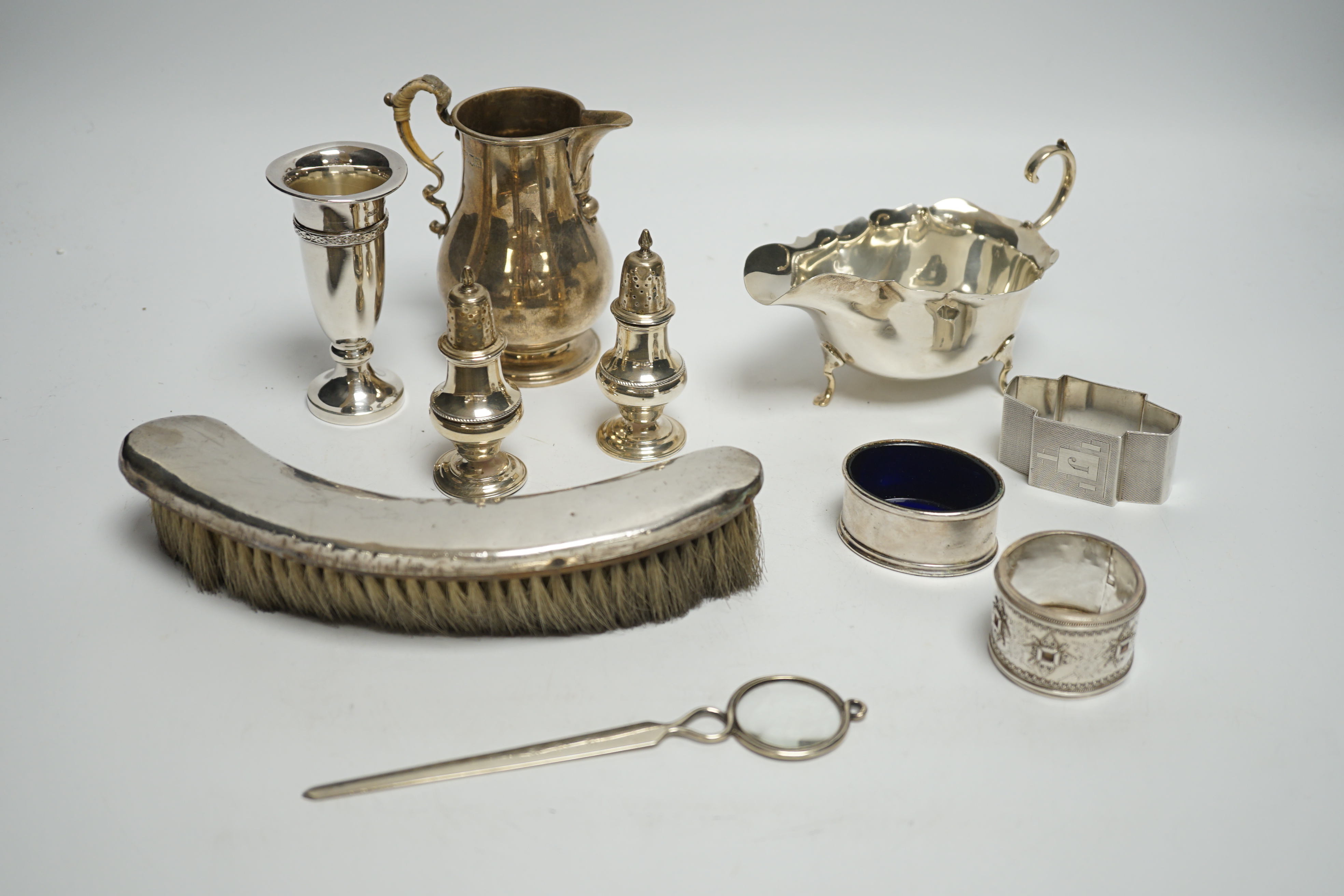 Sundry small silver including a silver sauceboat, George V sparrow beak cream jug, pair of pepperettes, napkin rings etc. and a letter opener/magnifying glass by Charles & George Asprey, London, 1908.